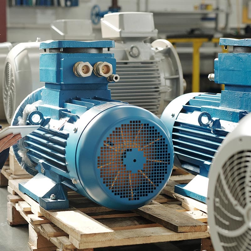 Industrial motors staged on a wooden pallet